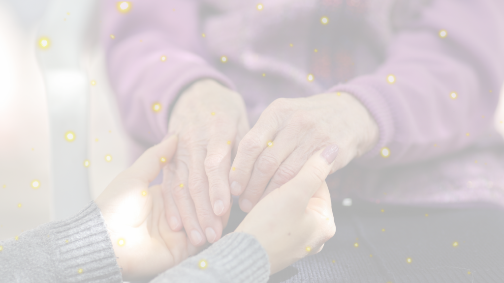 image shows a hospice nurse holding hands with a sick person