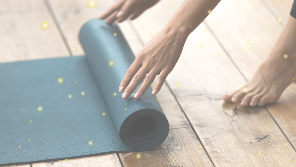 image shows someone rolling out a yoga mat