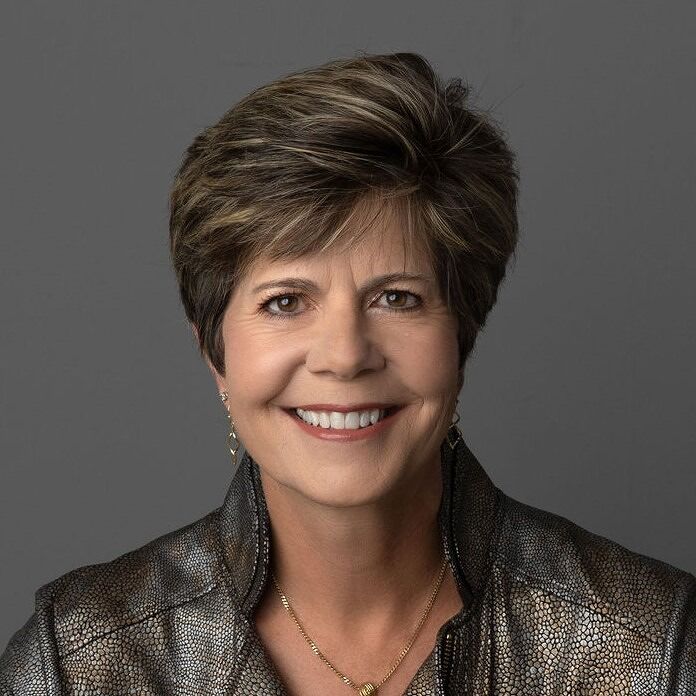 Suzanne Giesemann Hay House Author headshot smiling with jacket and necklace